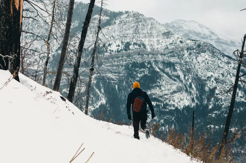 pexels-photo-19714008 Explore the winter wilderness of Waterton Park with a hiker in snowy mountains.