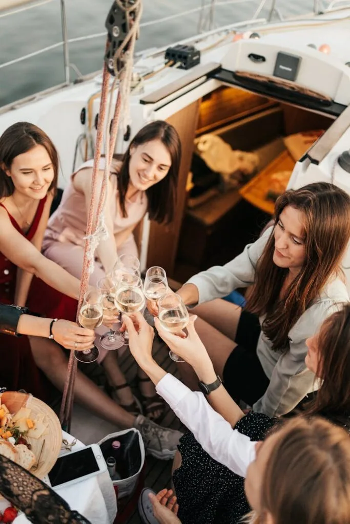 pexels-photo-5046443 A joyful group of women toasting with wine aboard a yacht, embodying leisure and friendship.